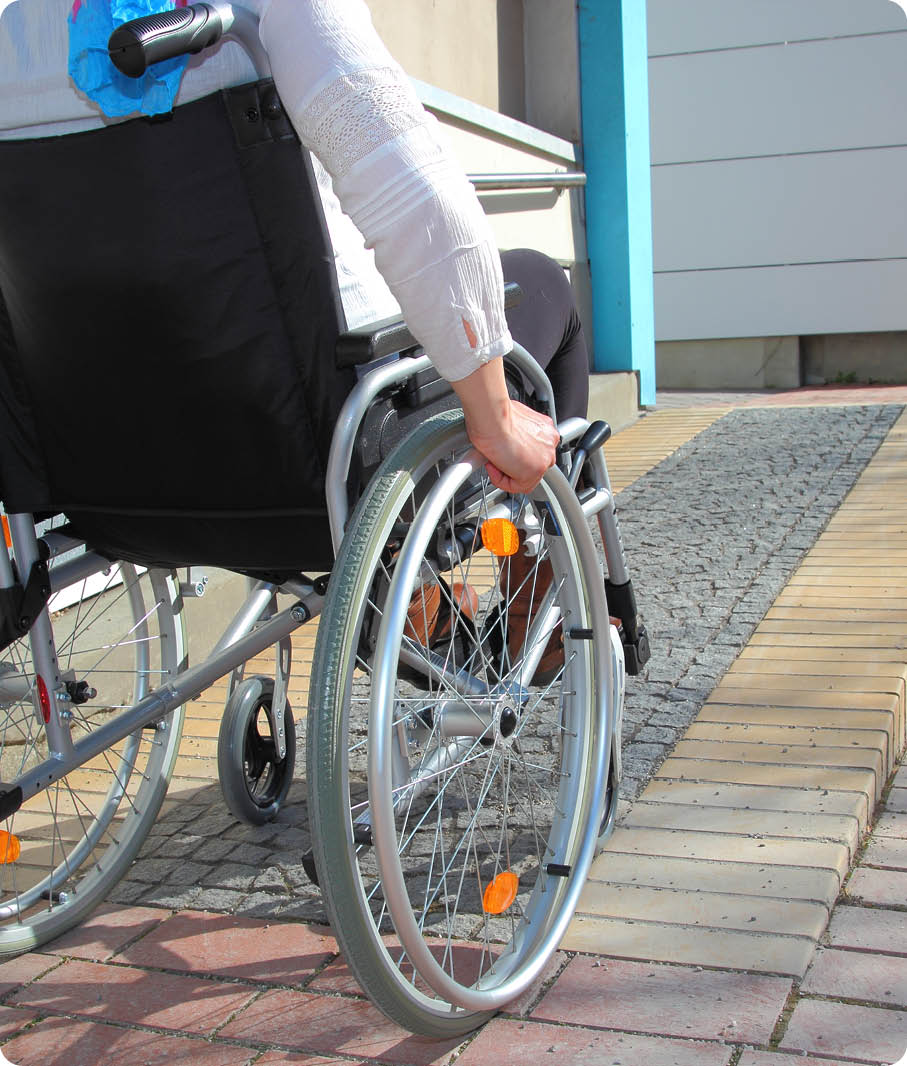 Woman in a wheelchair using a ramp 