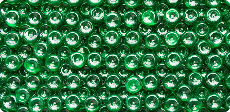 Bottling plant - Water bottling line for processing and bottling pure spring water into green glass bottles  Selective focus 