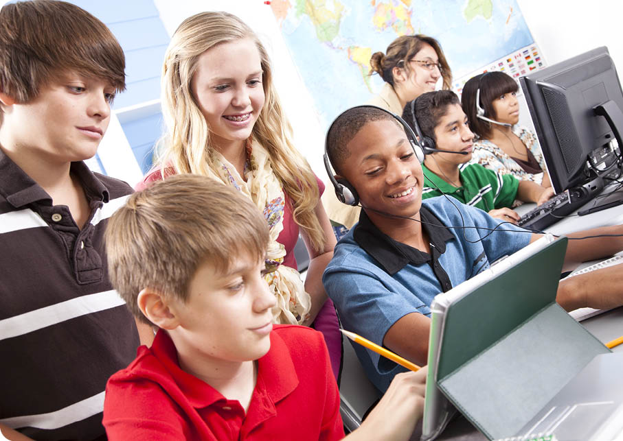 Teenage Students With Teacher In IT Class 