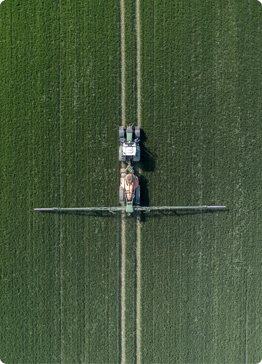 A Tractor Spraying Controversial Glyphosate Herbicide onto Farmland Aerial View 