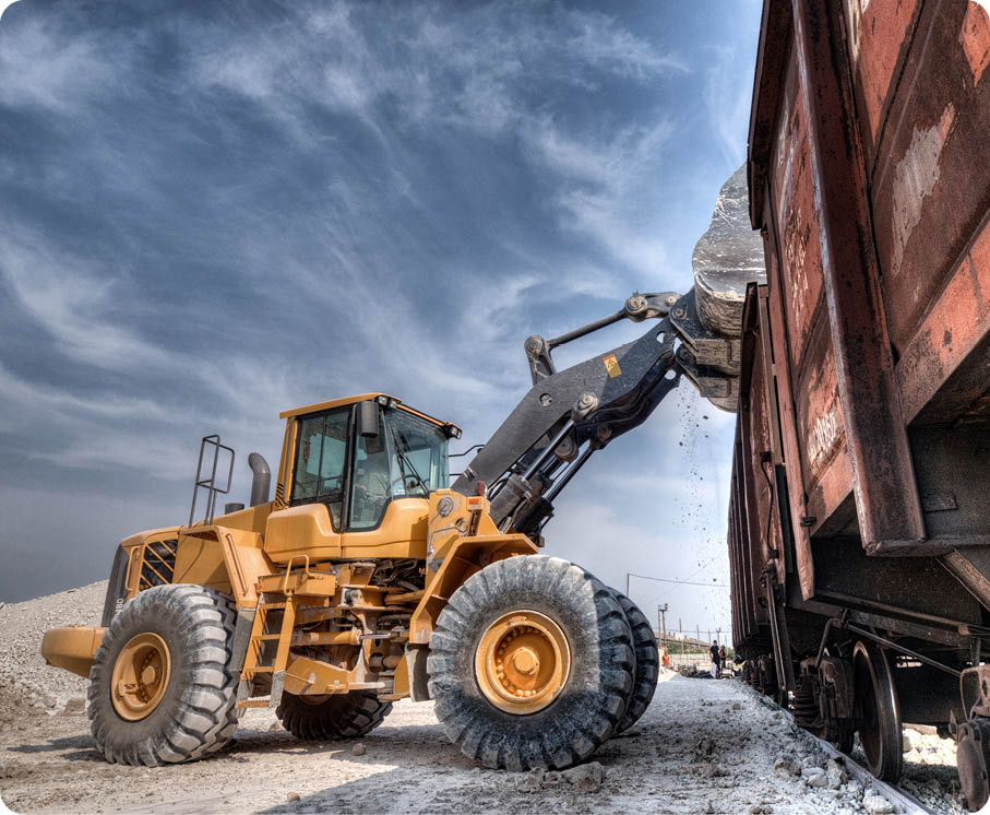 Wheel loader excavator with backhoe unloading clay 