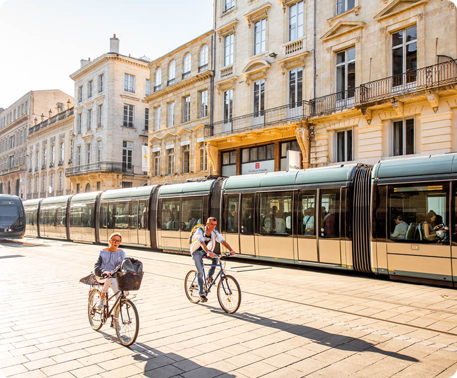 BORDEAUX, FRANCE - May 24, 2017: Street view with people ride a bicycles and modern trams in Bordeaux city during the morning in France 