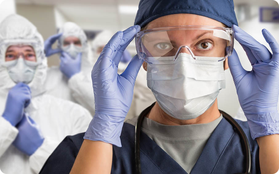 Team of Female and Male Doctors or Nurses Wearing Personal Protective Equipment In Hospital Hallway 