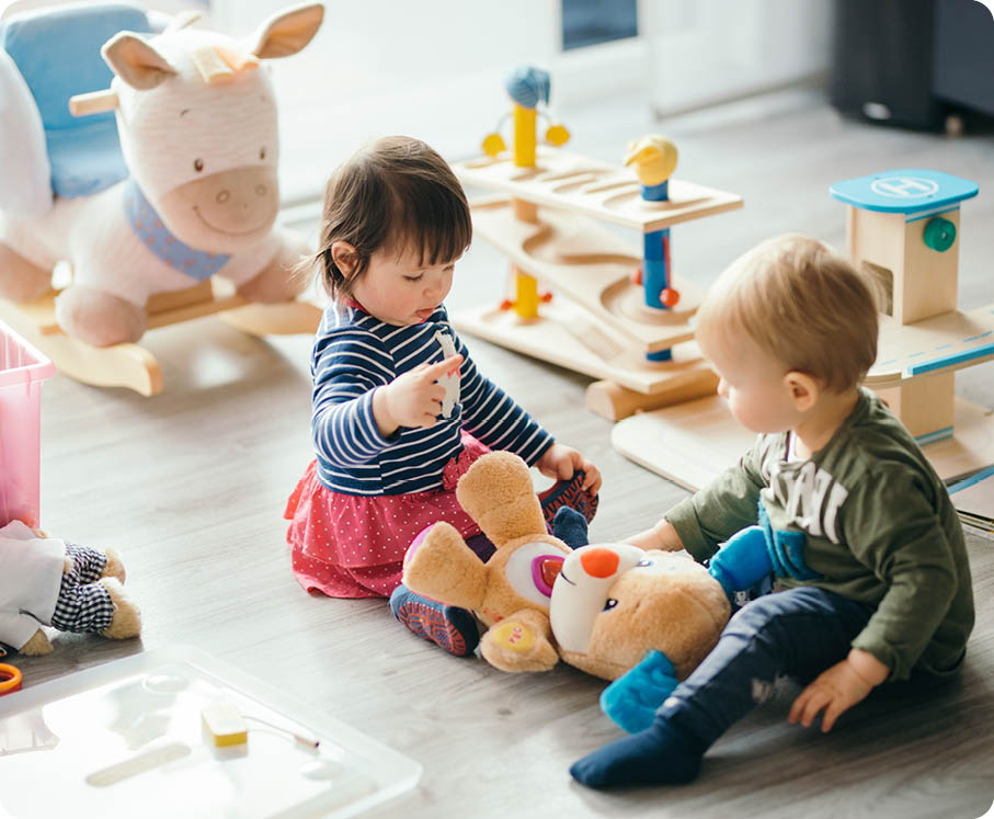 Cute little girl and boy playing with toys by the home 